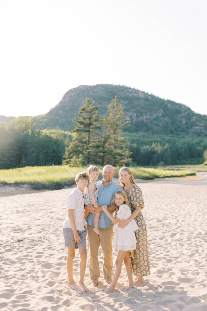 a family of 5 standing on Sand beach in front of beehive mountain